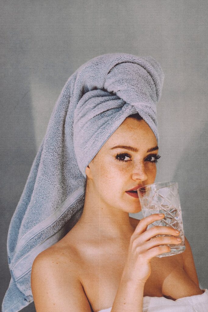 woman with glass of water after shower