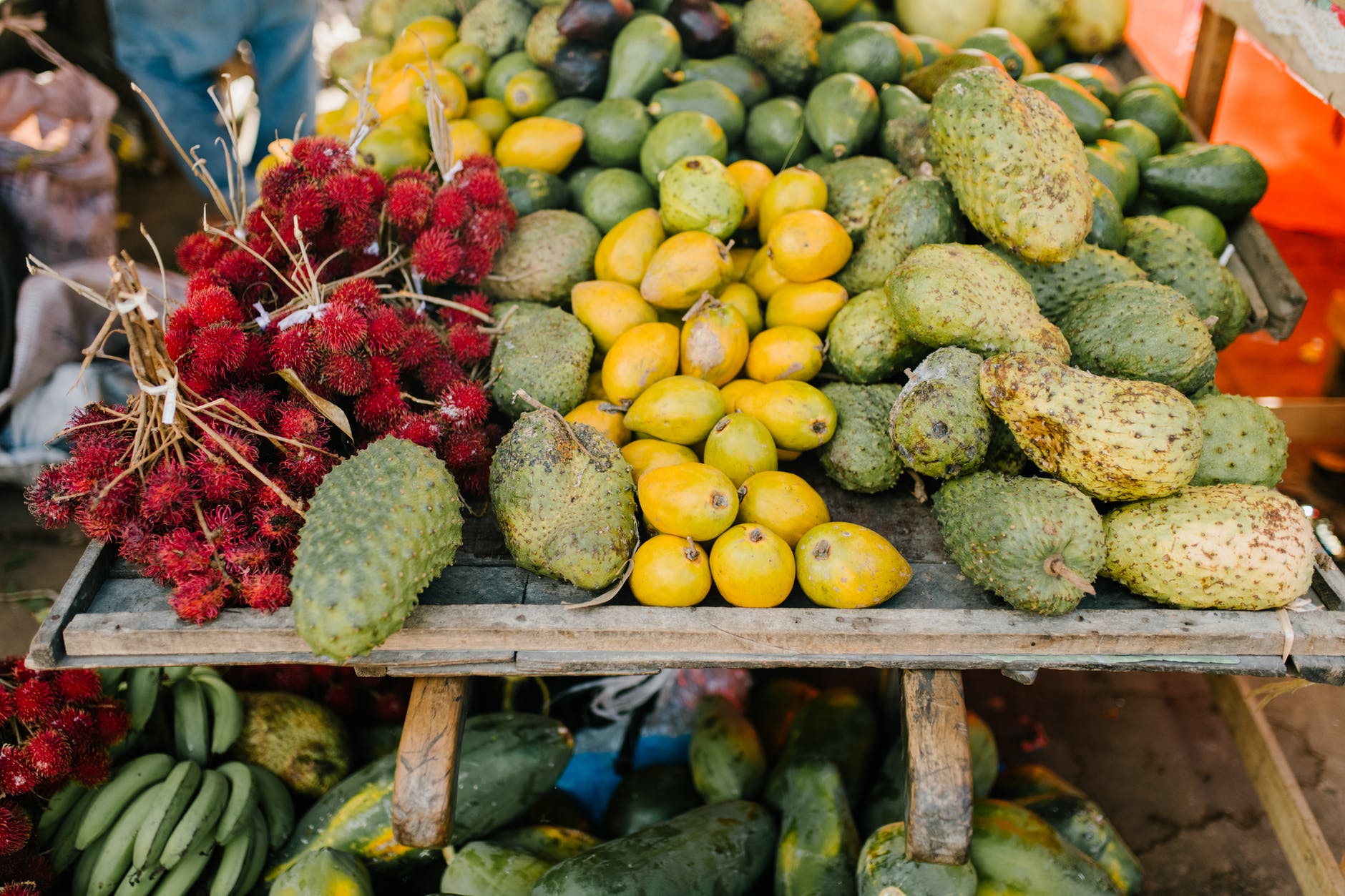 assorted tropical fruits on stall at market