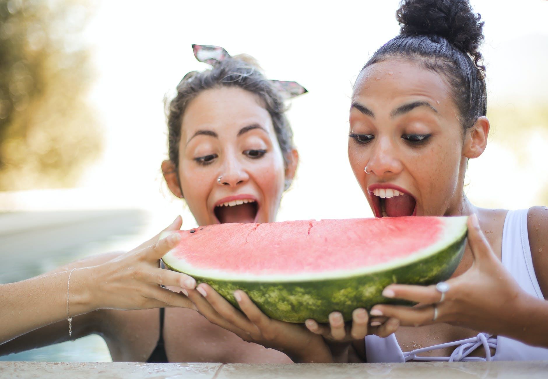 photo of women eating watermelon